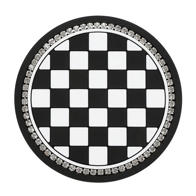 Black and white checkerboard pattern PVC plastic car cup holder mat placed in a vehicle centre console.