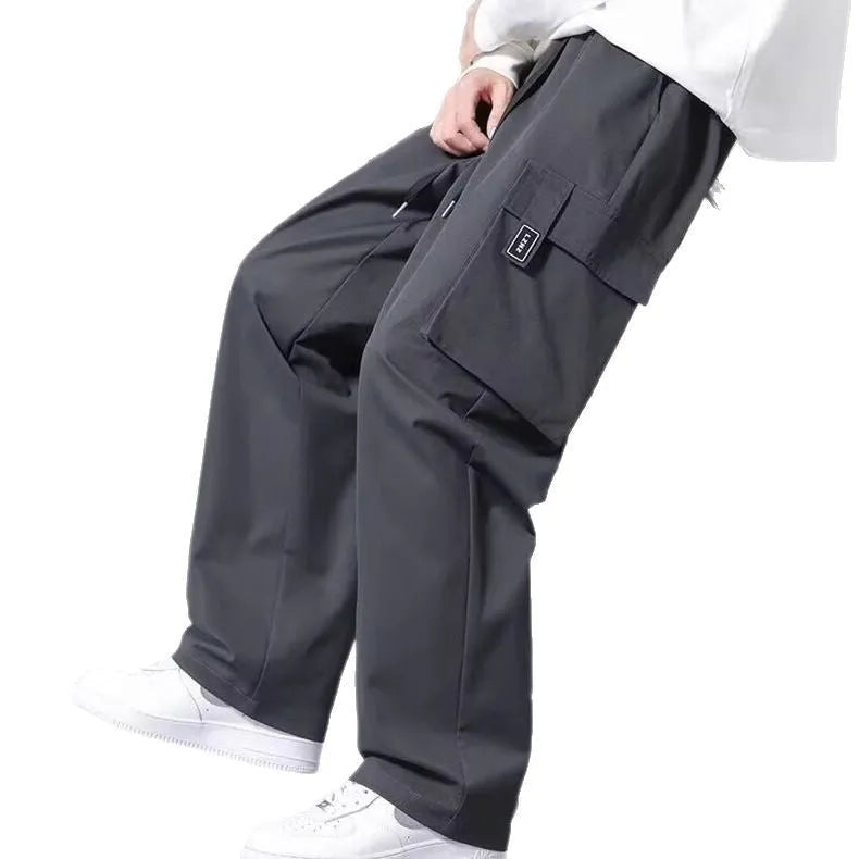 Boys' straight leg cargo pants in army green with drawstring waist and large cargo pockets.
