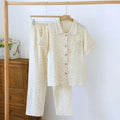 Women's loose blue Flower Sea pattern cotton gauze short-sleeve top and trouser set laid flat.
