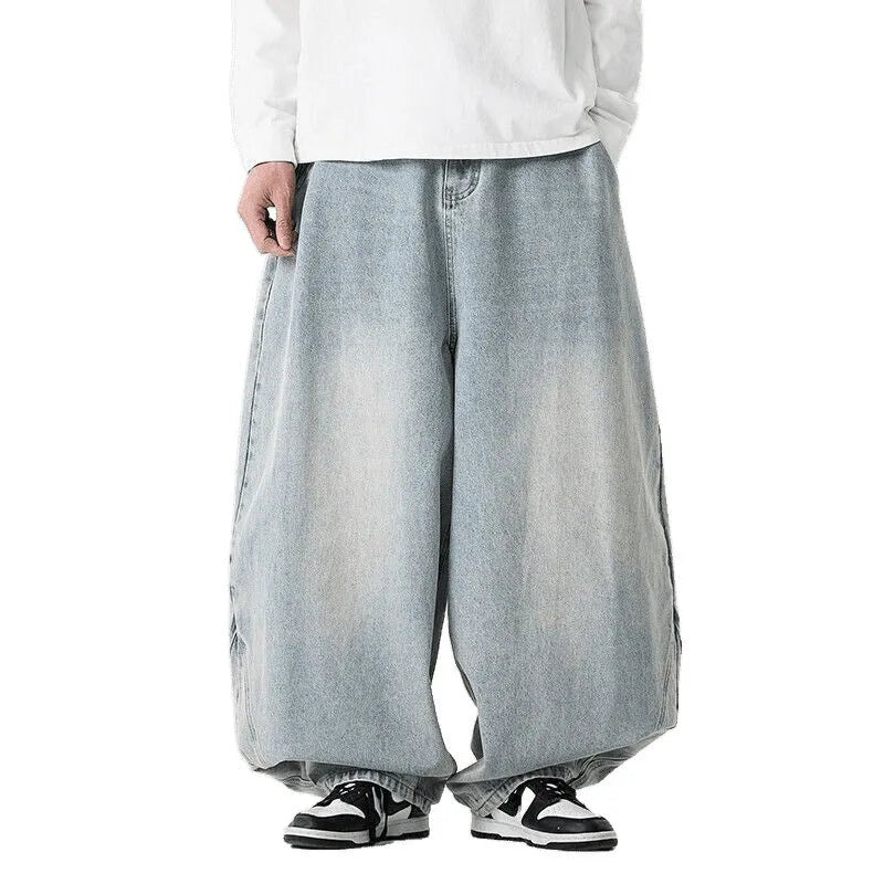 Men's loose fit light blue denim jeans with a straight leg and low waist, laid flat.