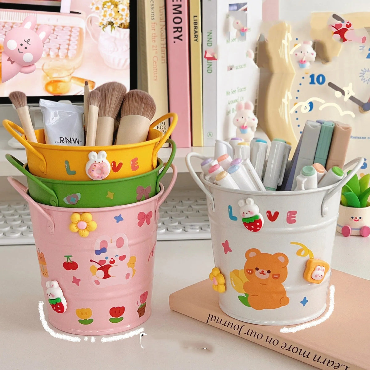 Round metal pen holder with iron art design in various colour options on a desk