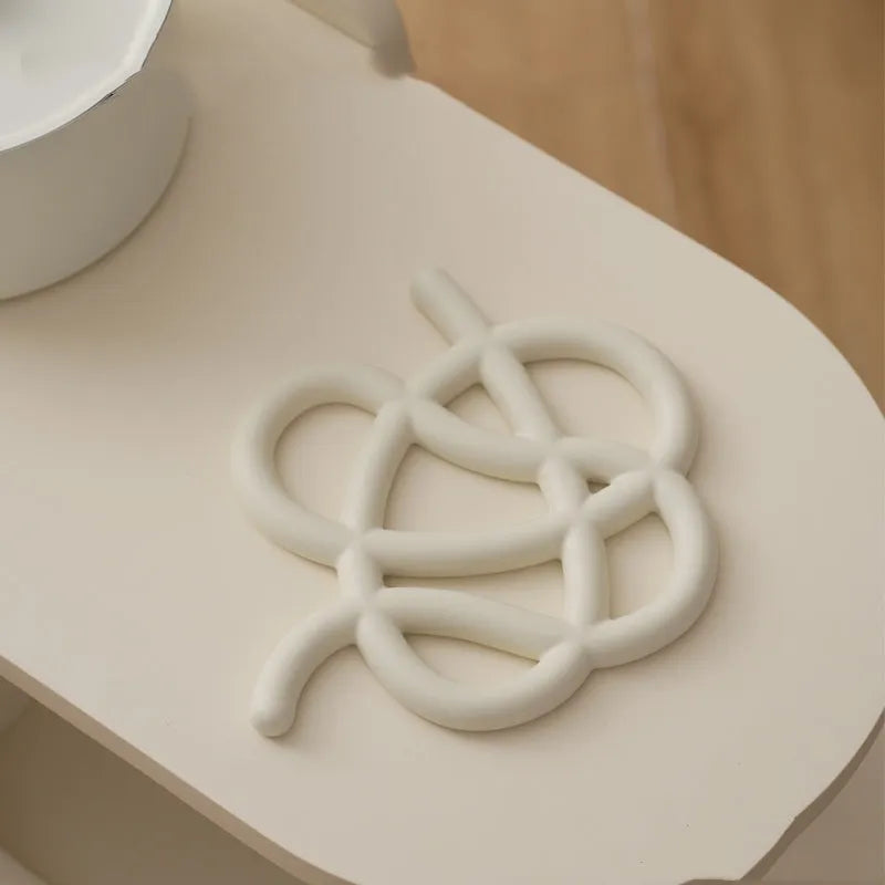 Ceramic heat proof placemat in irregular shape on a dining table