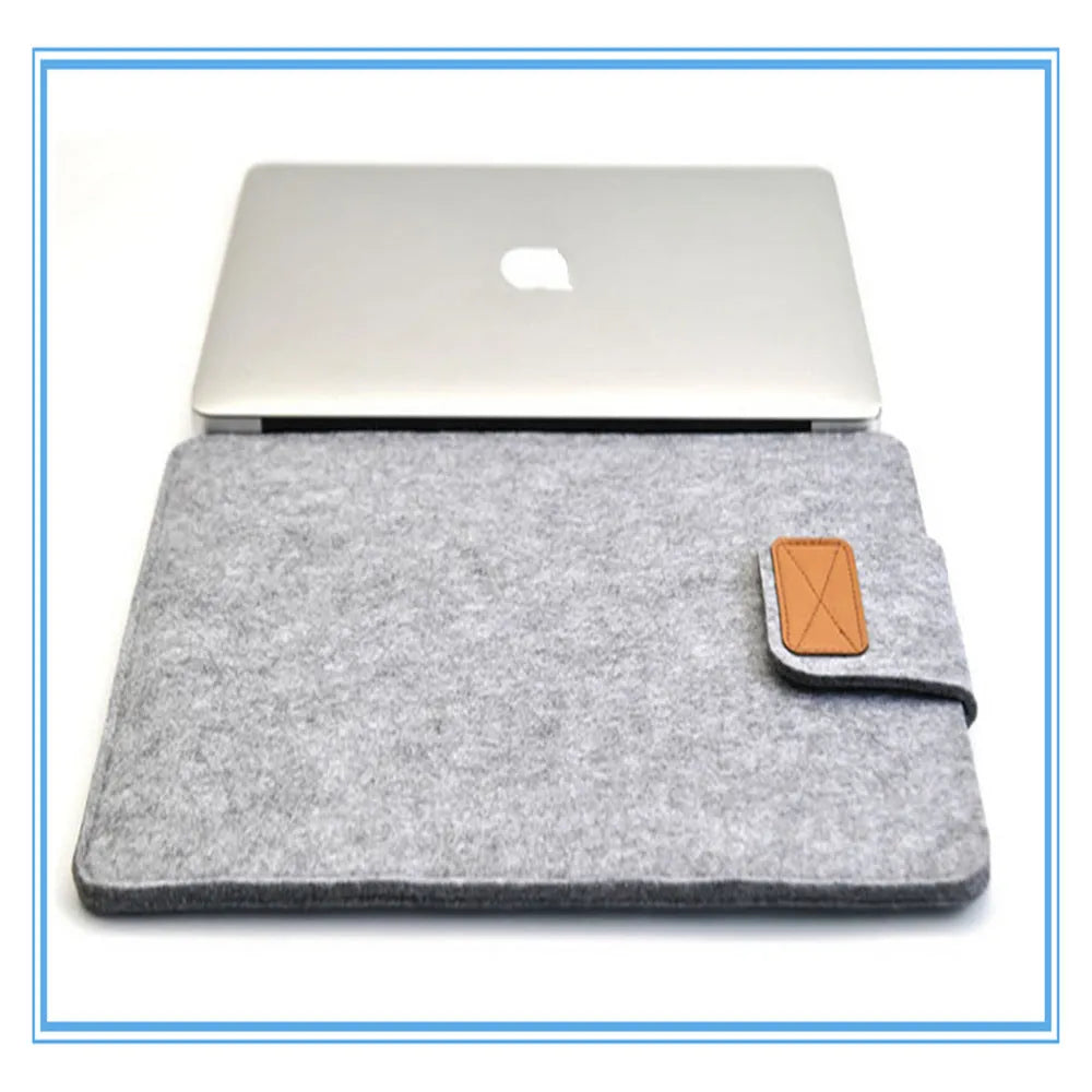 Dark grey clamshell laptop bag made of woven plush material, shown open to reveal the internal computer compartment.