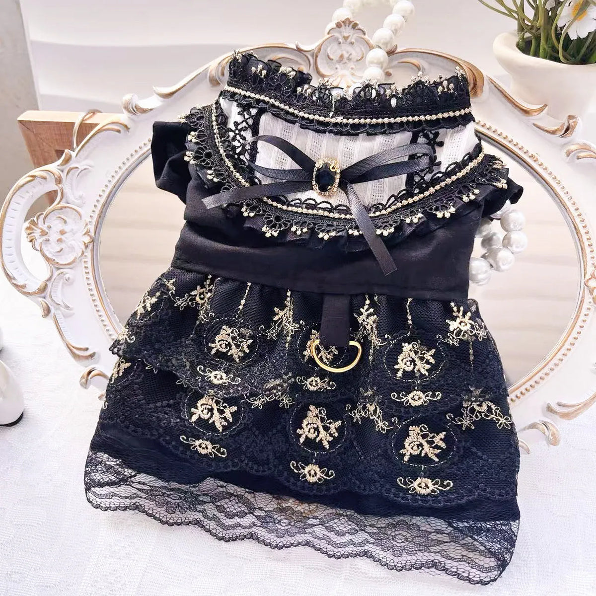 Golden gothic princess-style tiered skirt dress for a small dog or cat on a mannequin.