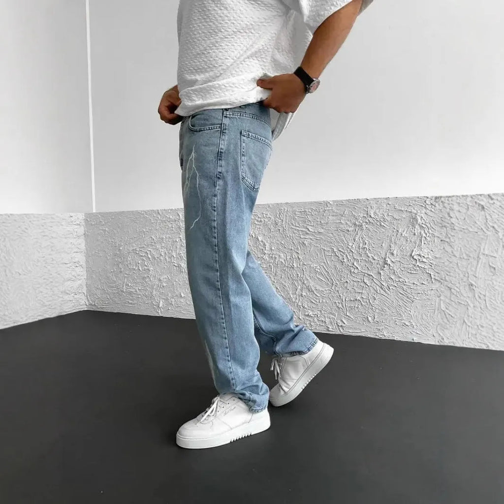 Men's blue straight-leg denim jeans with loose wide-leg cut and zip fly