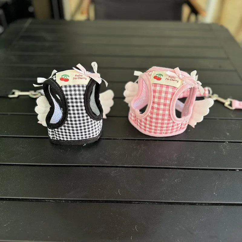 Pink cotton chest and back harness with lead for a small dog on a white background.