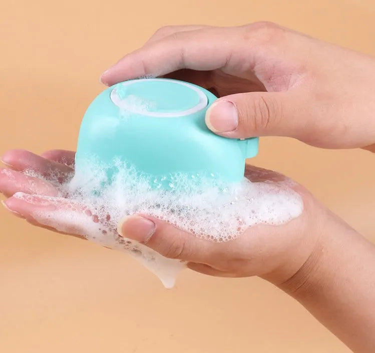 Blue silicone dog bath brush for washing and massaging pets during bath time.