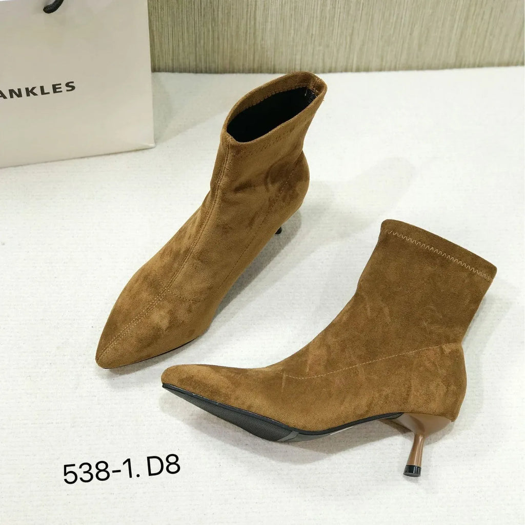 Women's black pointed toe ankle boots with a stiletto heel on a white background.