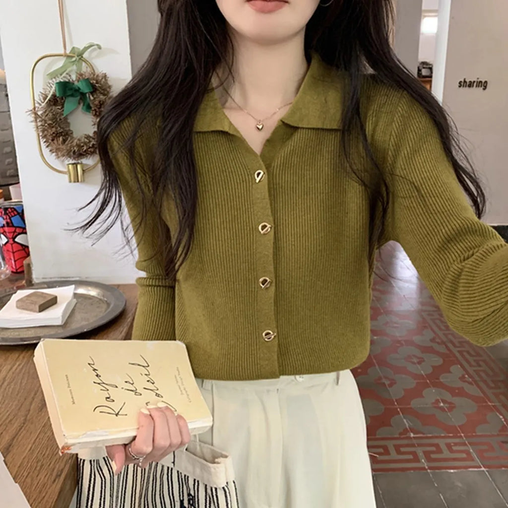 Beige long-sleeved viscose knitted cardigan hanging on a hanger, loose fit