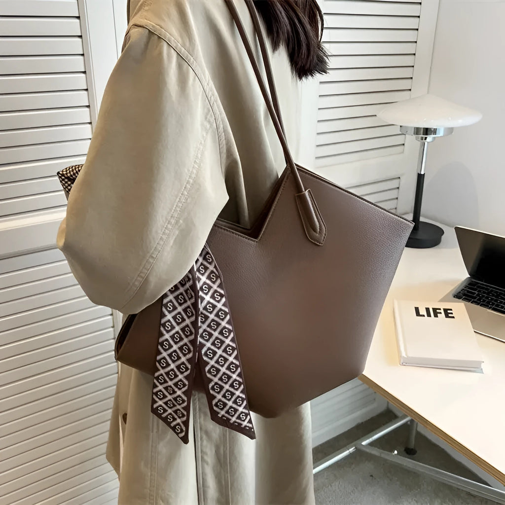 Women's large capacity shoulder bag in PU leather showing horizontal square shape and shoulder strap