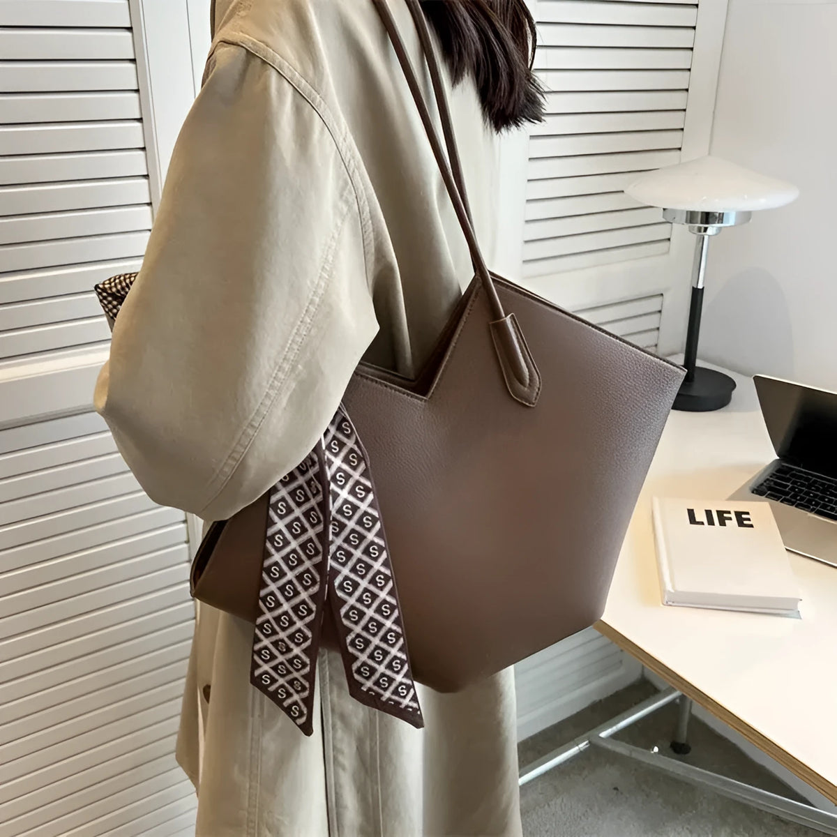 Women's large capacity shoulder bag in PU leather showing horizontal square shape and shoulder strap
