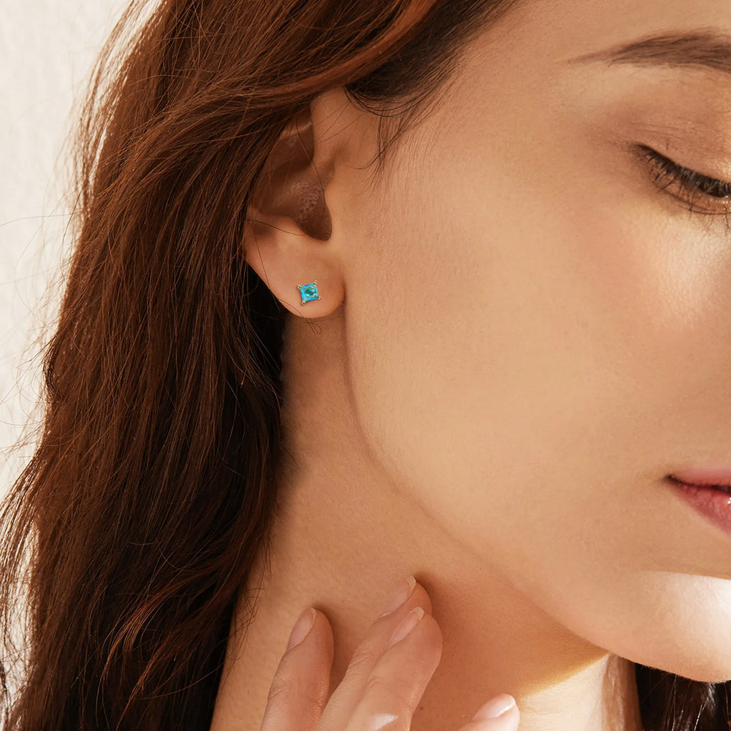 Gold-plated drop earring with a pear-shaped candy-coloured zircon stone on a copper setting.