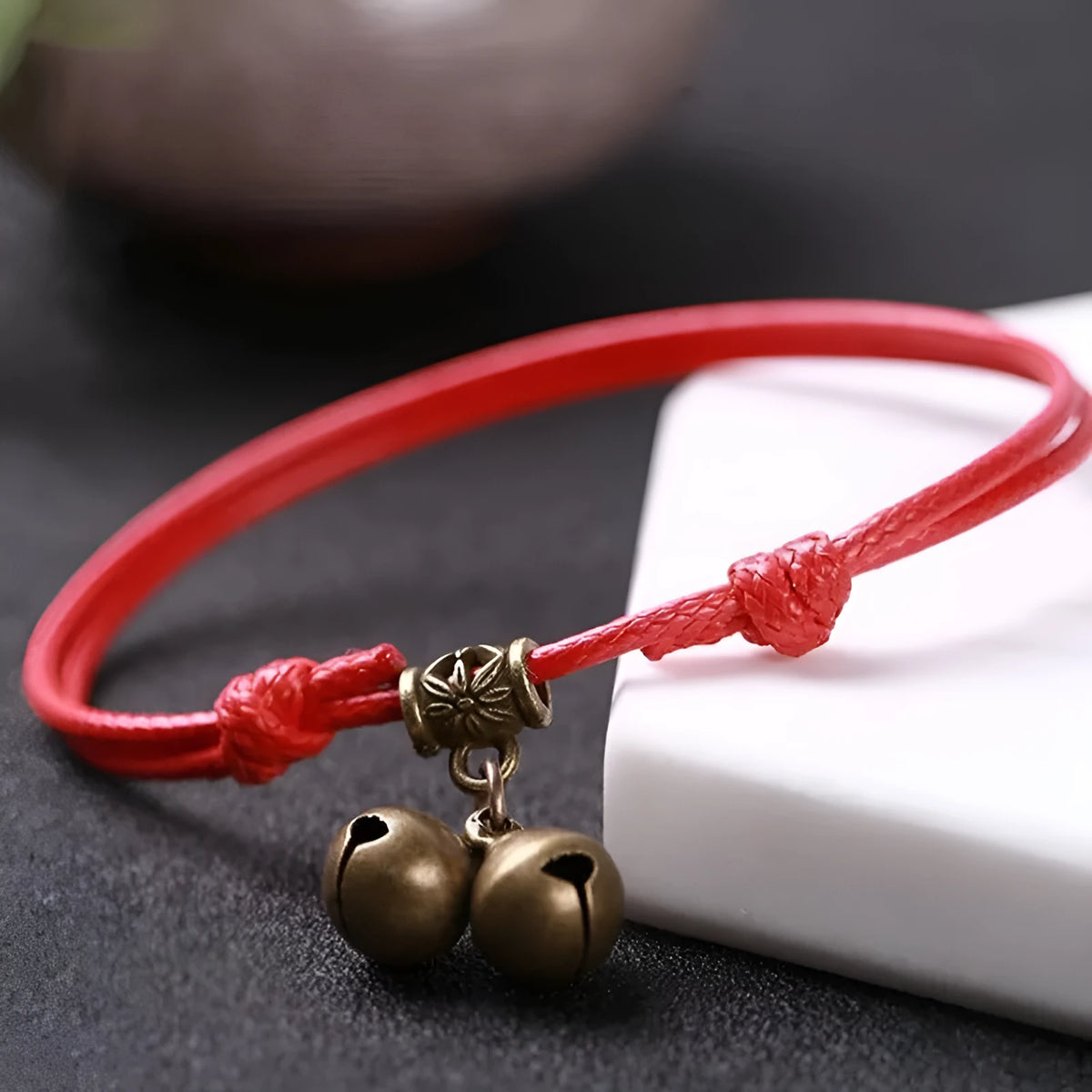 Nylon dog collar with brass bell shown in black rope colour, suitable for small to medium dogs.