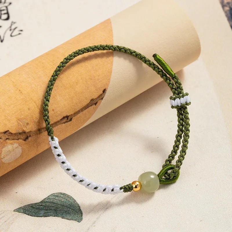 Hetian jade and sterling silver Chinese national bracelet on spring green cord carrying strap
