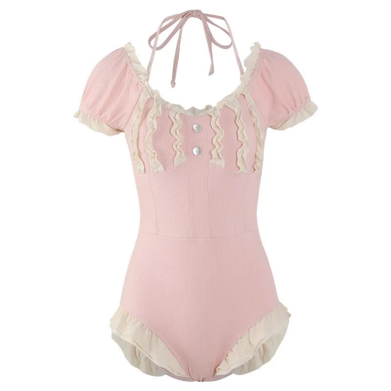 Pink women's conservative one-piece nylon swimsuit on a hanger.