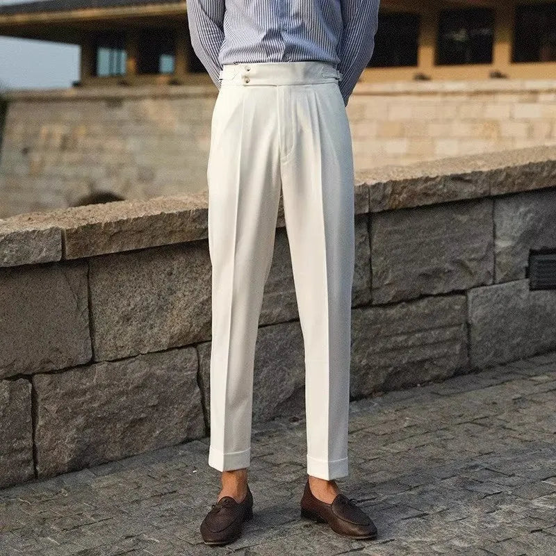 Men's slim fit straight-leg suit trousers in black, white, and apricot colours on a hanger.