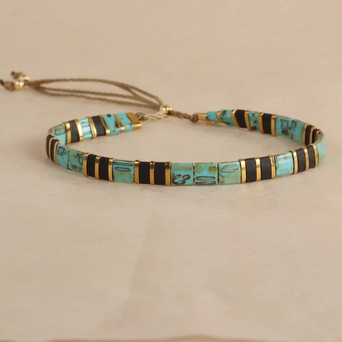 Glass bead geometric bracelet with round beads in five colour variations on wrist