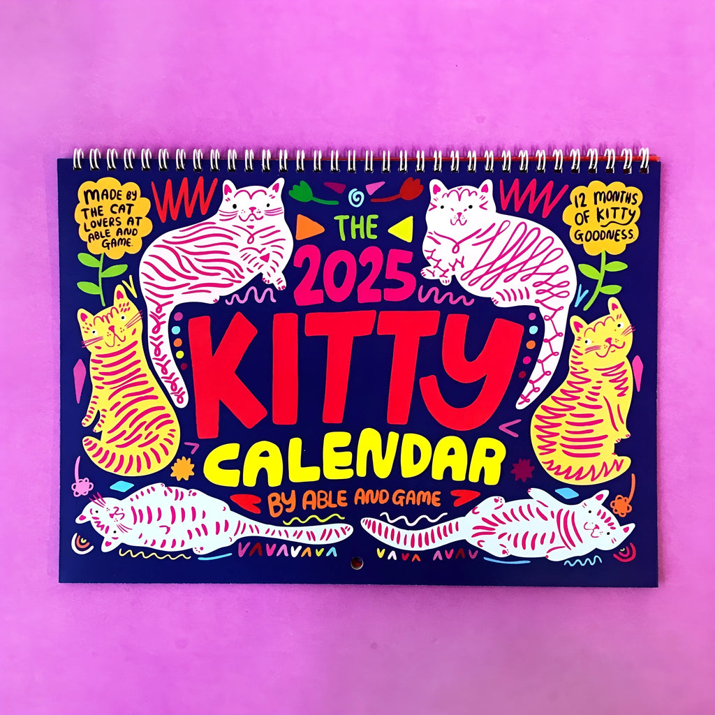 A4 cat wall calendar showing a monthly page with a cat photograph and date grid