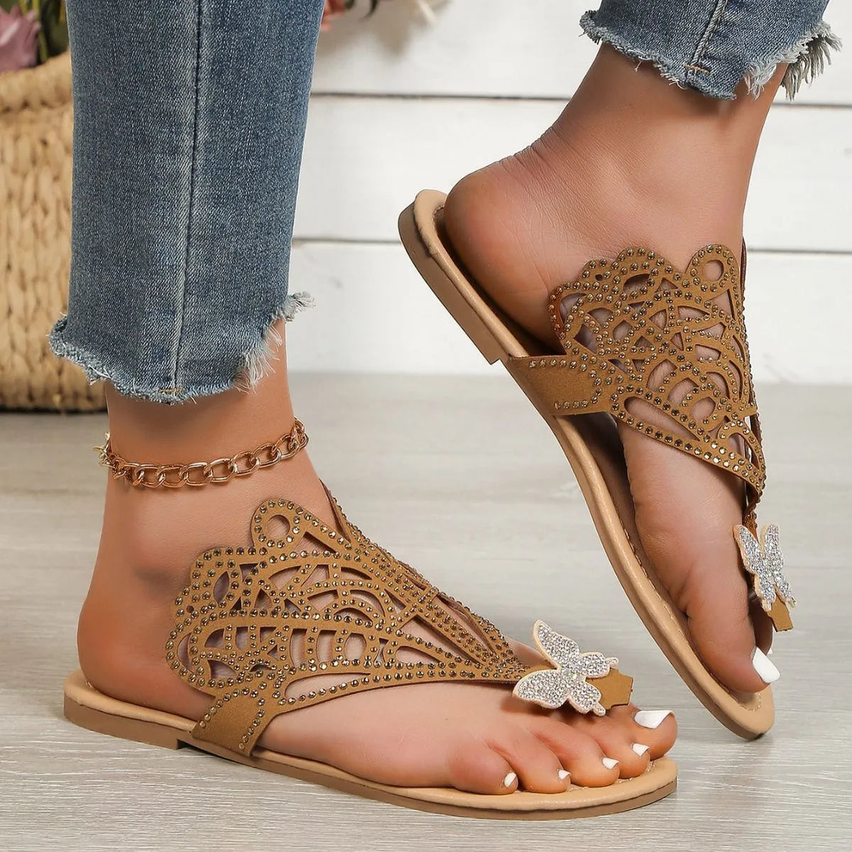 Women's gold slip-on sandals with rhinestone decoration and open flip-toe design.