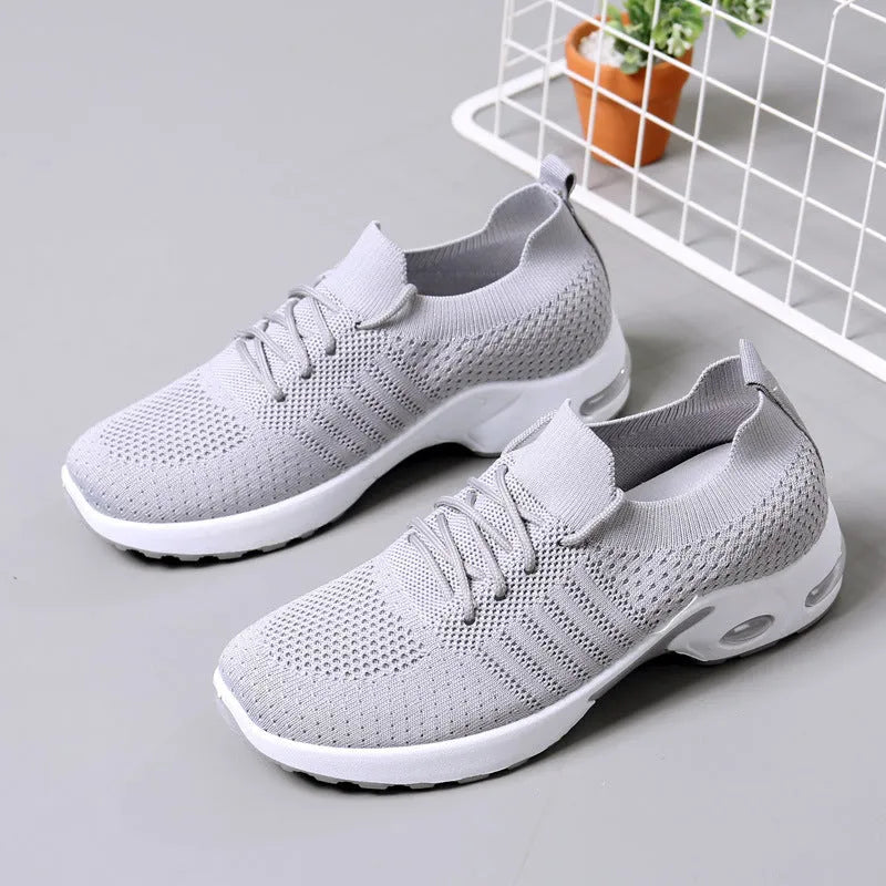 Women's round-toe lace-up sneaker in grey mesh with a soft PVC sole.