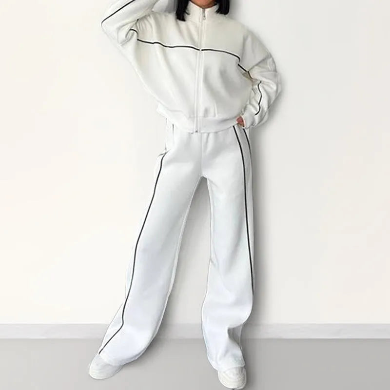 Casual two-piece suit set with a mock neck zip hoodie and striped trousers on a hanger.