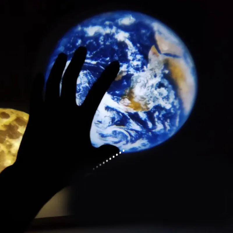 USB-powered earth and moon star projector night light with adjustable hose bracket on a bedside table.