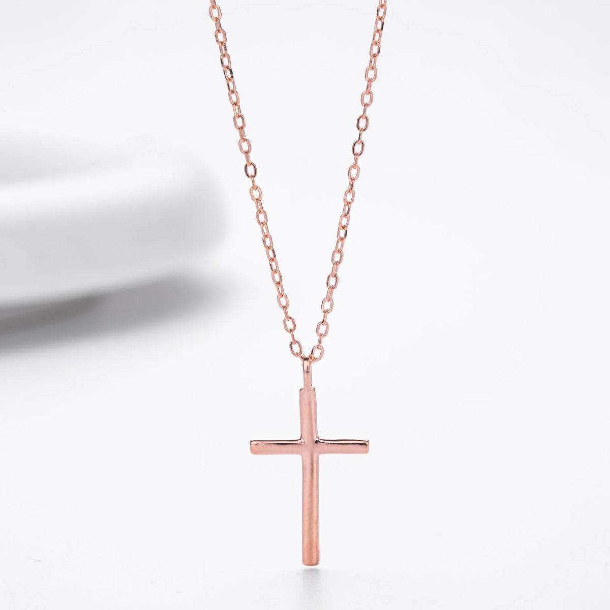 Simple glossy cross pendant on an adjustable O-chain sterling silver necklace in gold plating