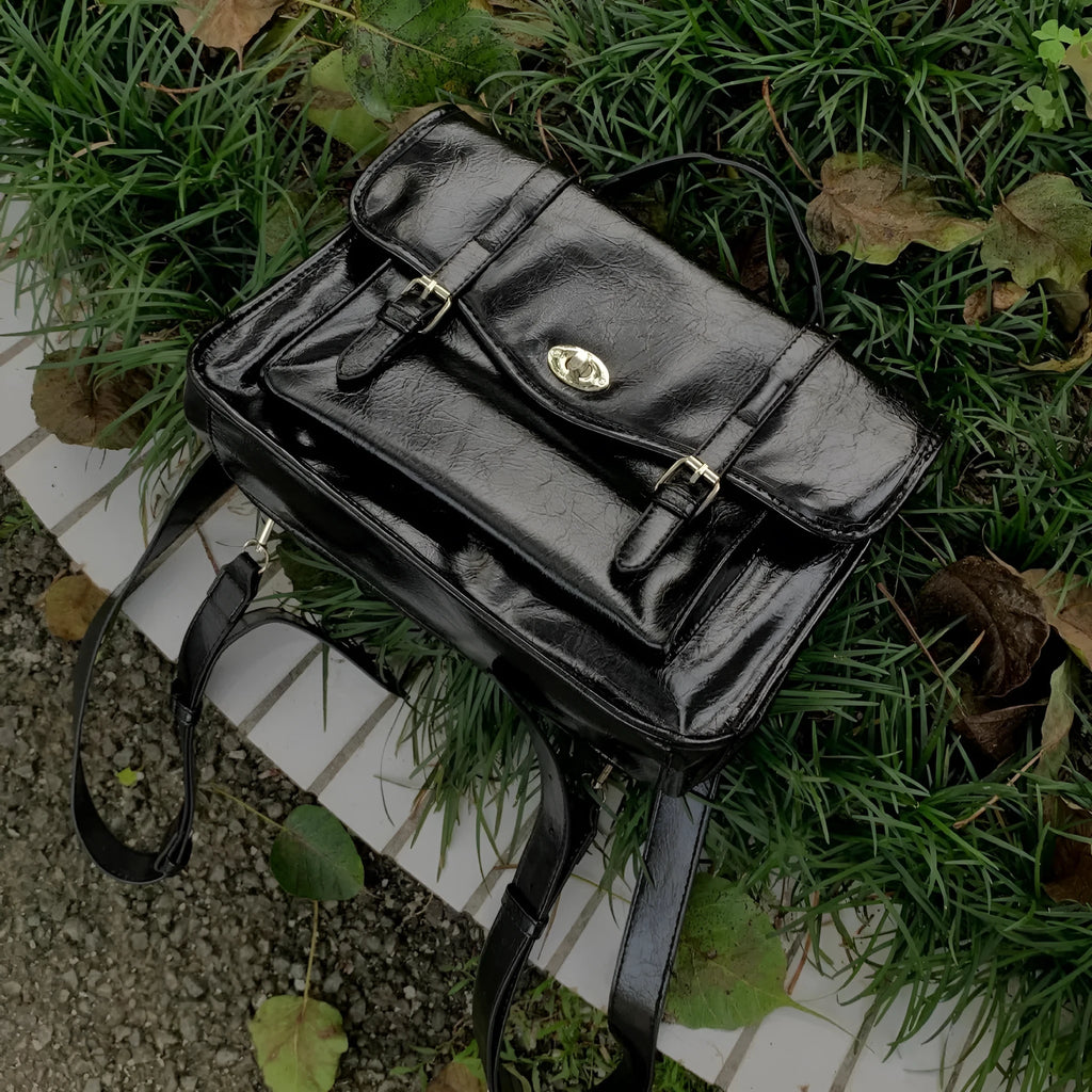 Black college messenger bag with oil wax leather finish showing 35cm length dimensions