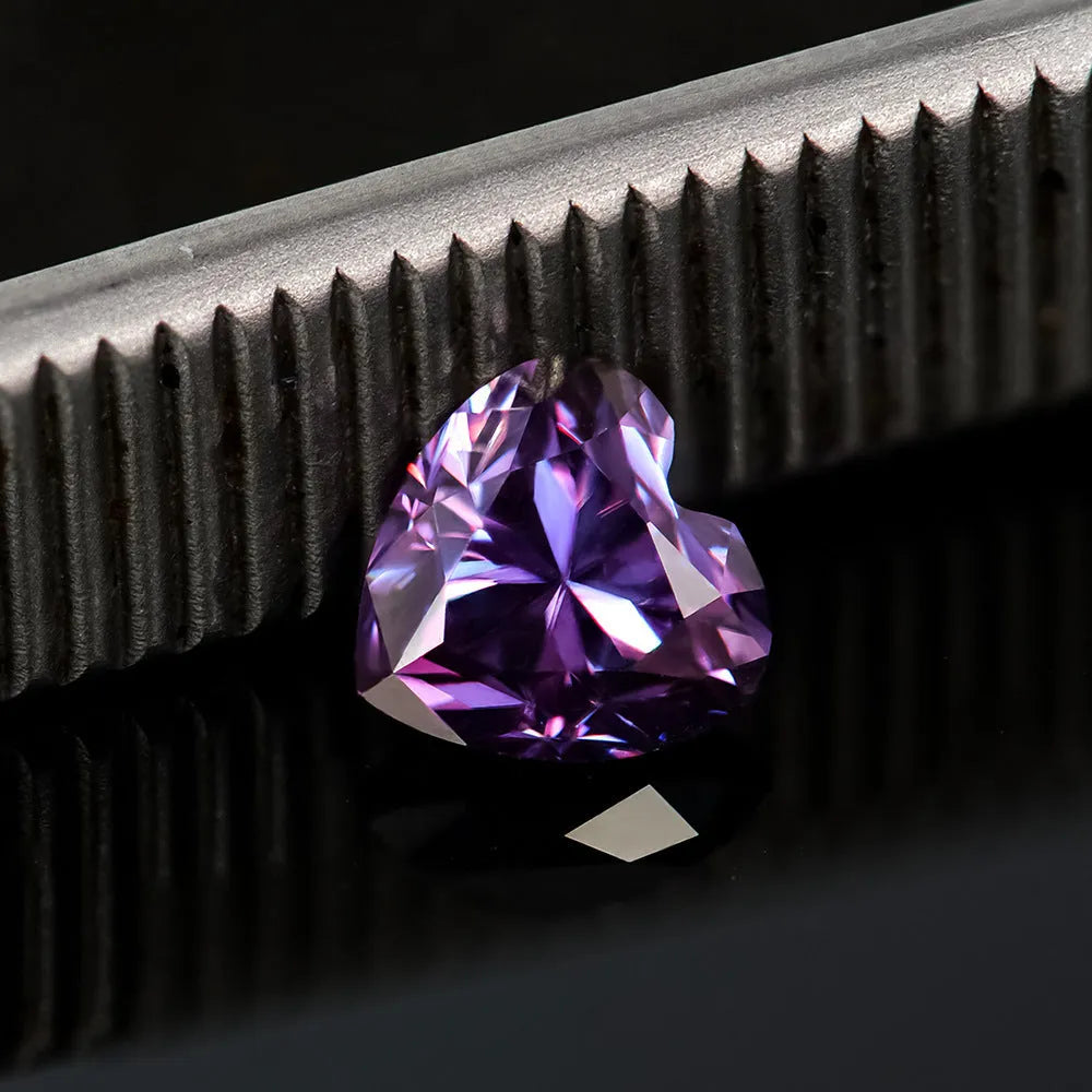 A loose lemon yellow moissanite gemstone cut into a heart shape, shown alongside other colour options.