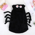 Dog wearing a black and white spider web print Halloween costume with elastic neck.