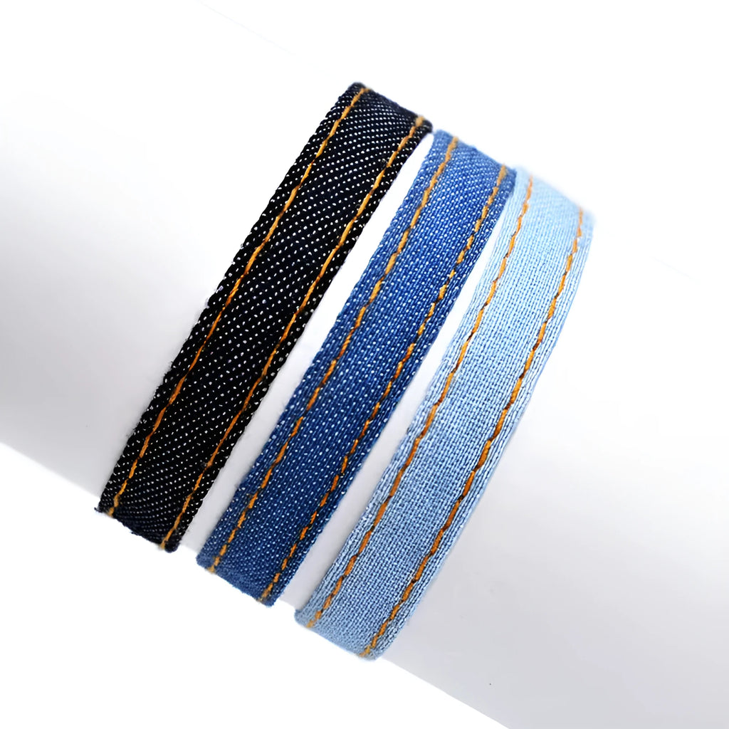 National style denim fabric unisex bracelet carrying strap laid flat.