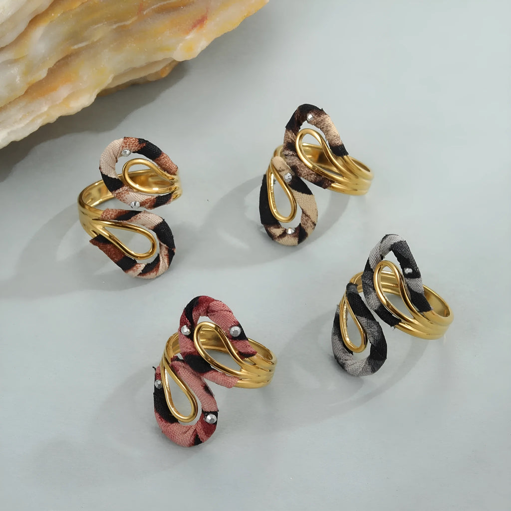 Leopard print geometric open mouth stainless steel ring on a grey background.