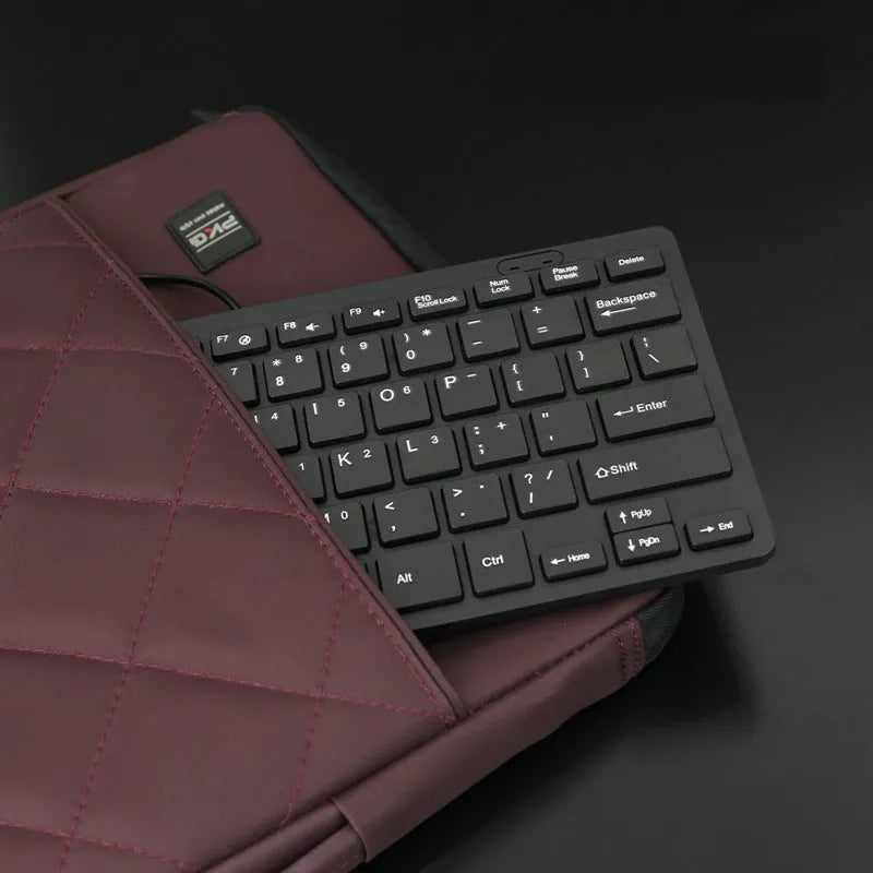 Compact USB wired keyboard in four colour options showing dimensions and quiet key design