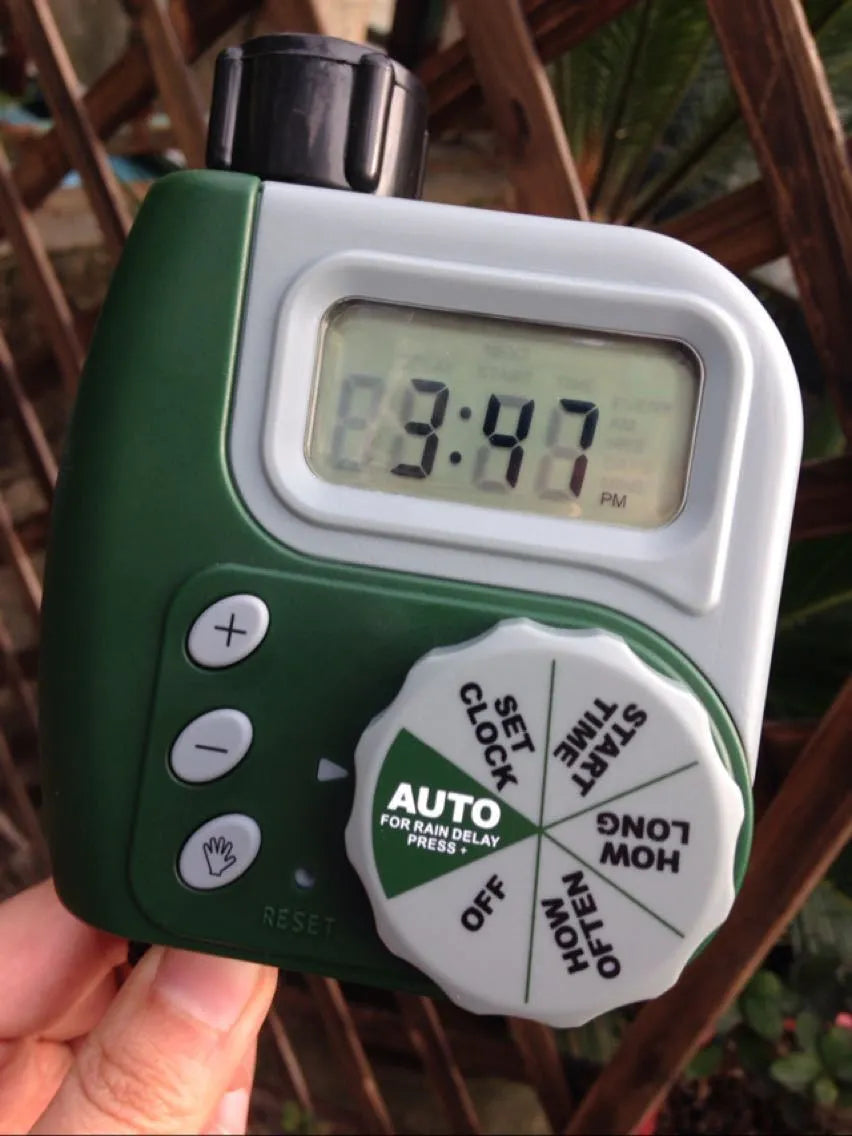 Green digital hose faucet timer with copper connector for automatic garden watering systems