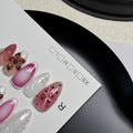 Close-up of hand-painted 3D nail patch with embossed candy pattern on an almond-shaped nail.