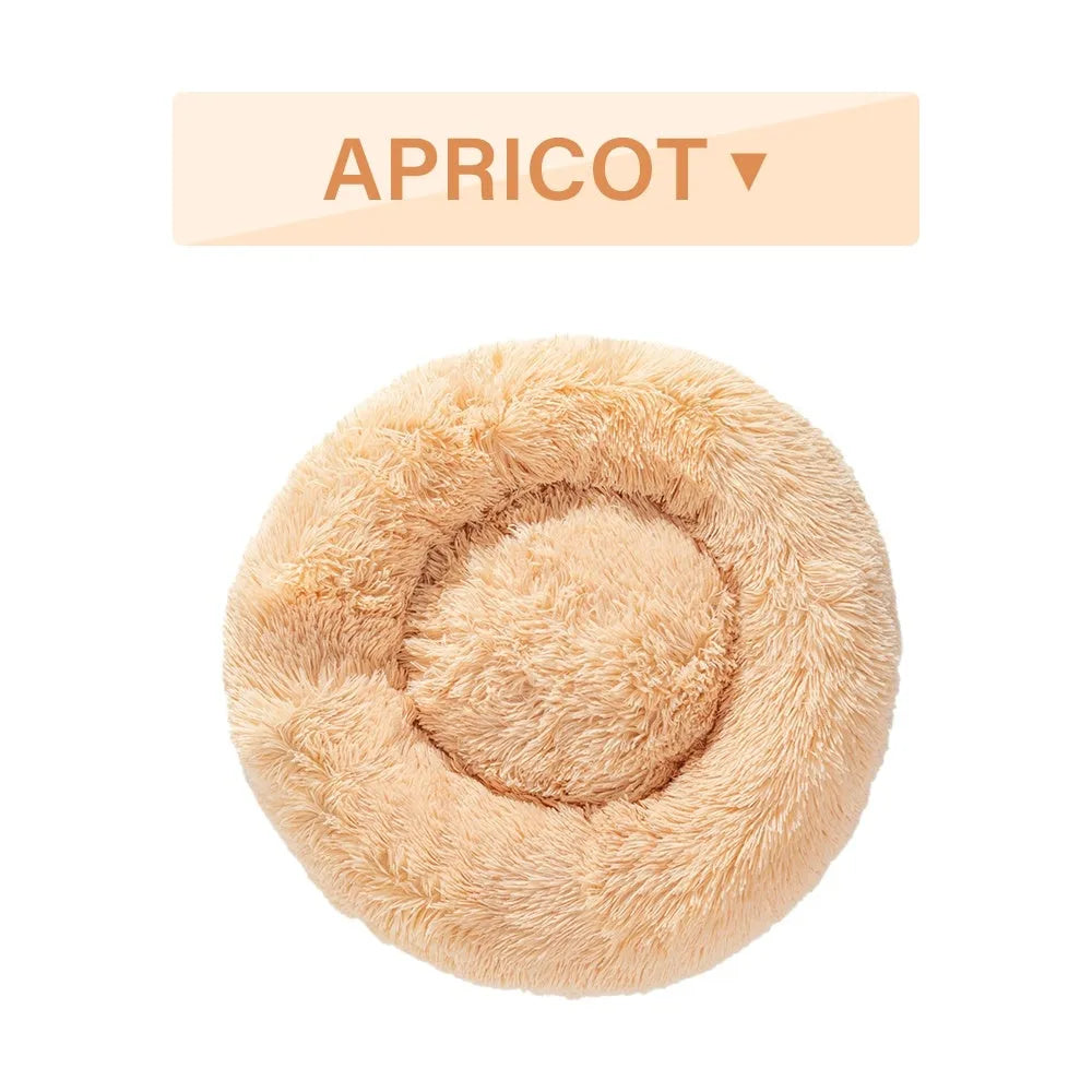 Fluffy donut-shaped dog bed in long plush material, shown in one of multiple available colours