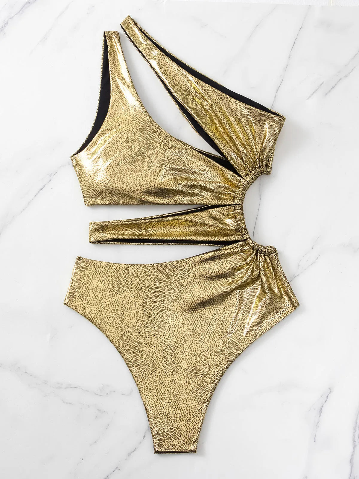 Gold backless one-piece swimsuit for women on a white background.