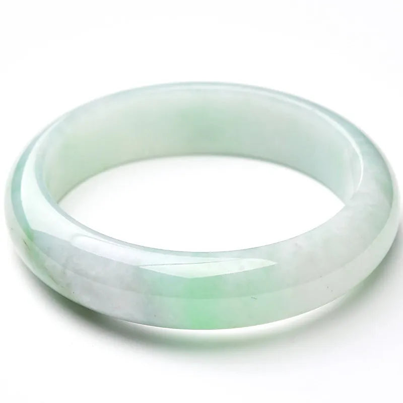 Light green jade bracelet showing natural stone colour and solid band construction