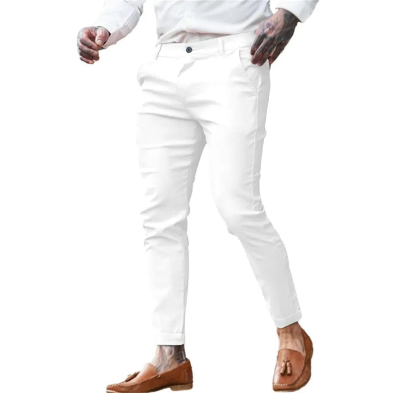 Men's slim pencil trousers in stretch cotton twill fabric on a hanger, showing the mid waist and slim leg cut.