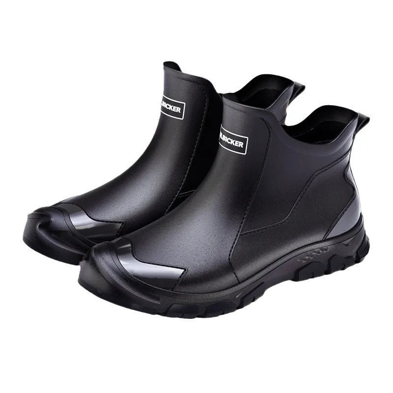 Short tube black PVC rain boots with round toe and flat heel on a non-slip plastic sole.