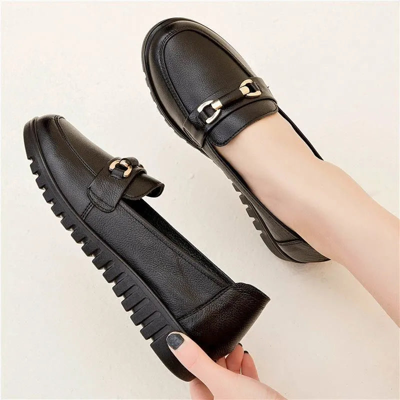 Black women's soft leather slip-on pumps with a rounded toe and low flat heel.