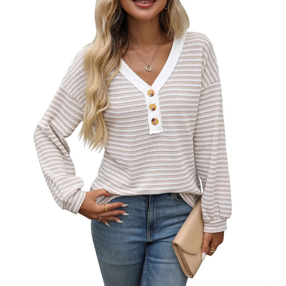 Women's loose-fitting long-sleeved V-neck top with button detail and patchwork design.