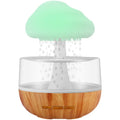White cloud-shaped humidifier with night lights and water droplet effect on desktop