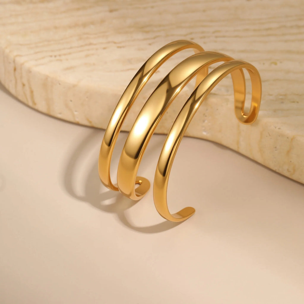 Stainless steel geometric open bracelet for women in gold or silver electroplated finish.