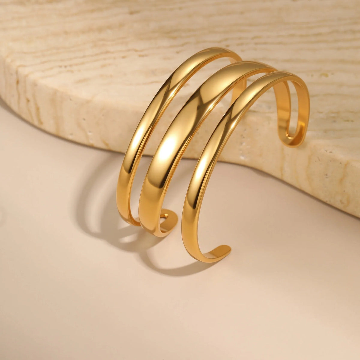 Stainless steel geometric open bracelet for women in gold or silver electroplated finish.