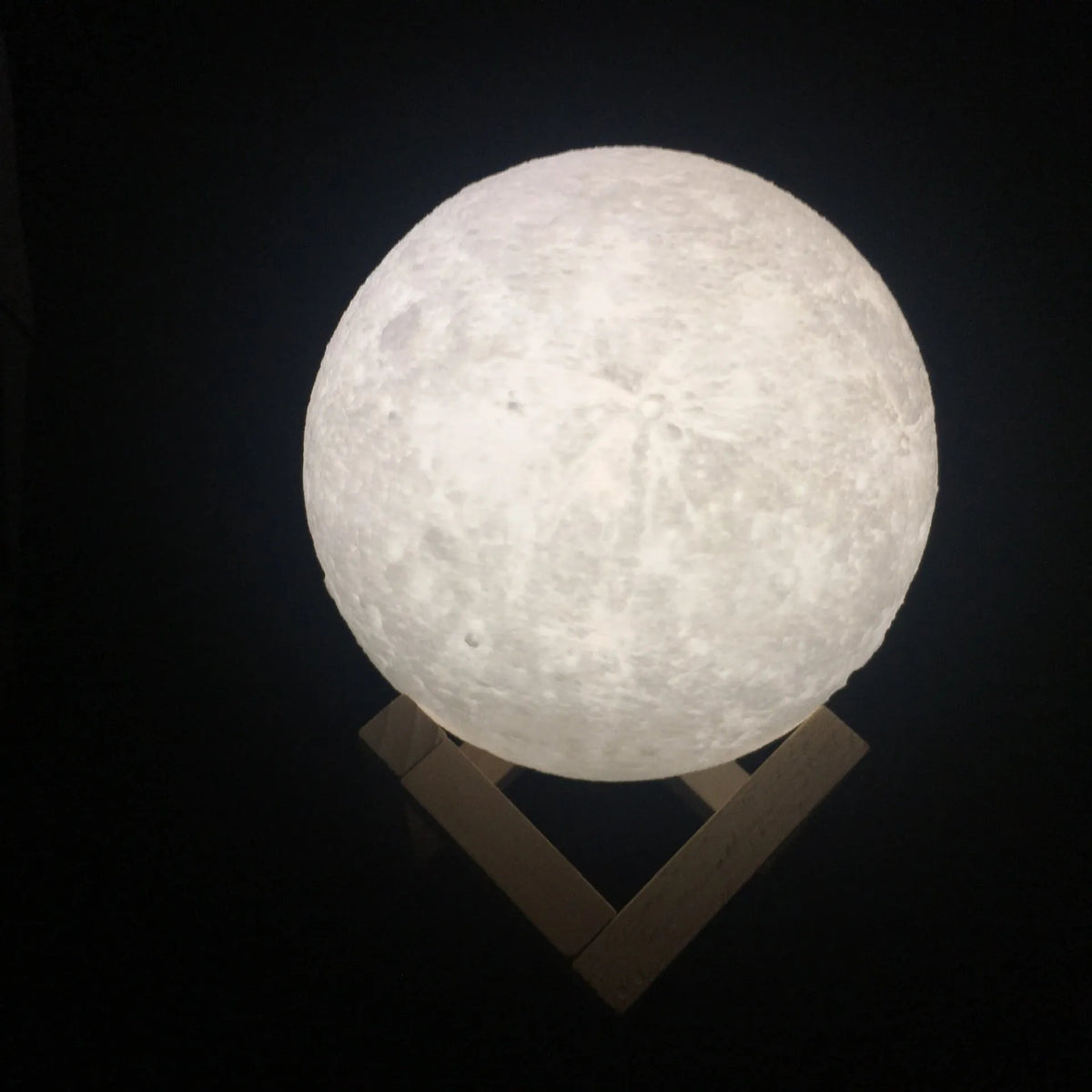 3D printed moon lamp on wooden stand showing touch ring and detailed lunar surface