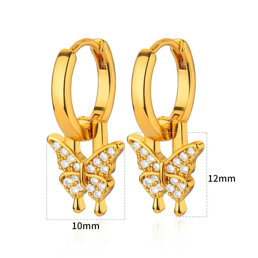 A pair of women's geometric butterfly-shaped earrings made from copper with heart and star details.