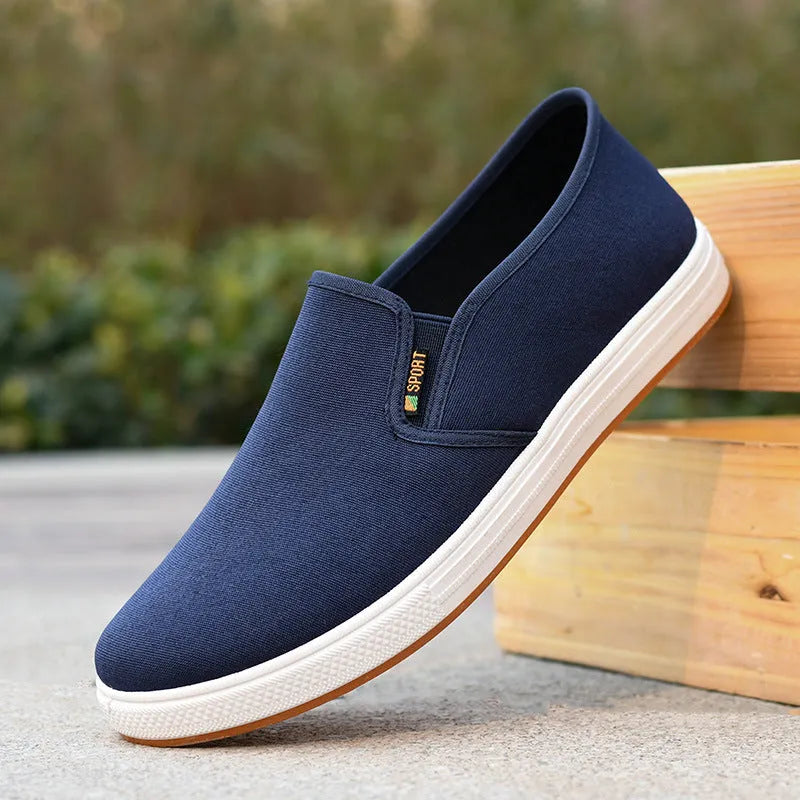 Men's black and blue low-top canvas slip-on shoes with round toe and composite soles
