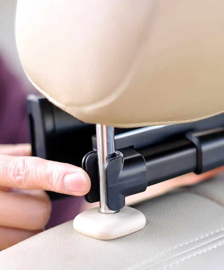 Black universal car phone holder mounted on car rear seat base with tablet in cradle