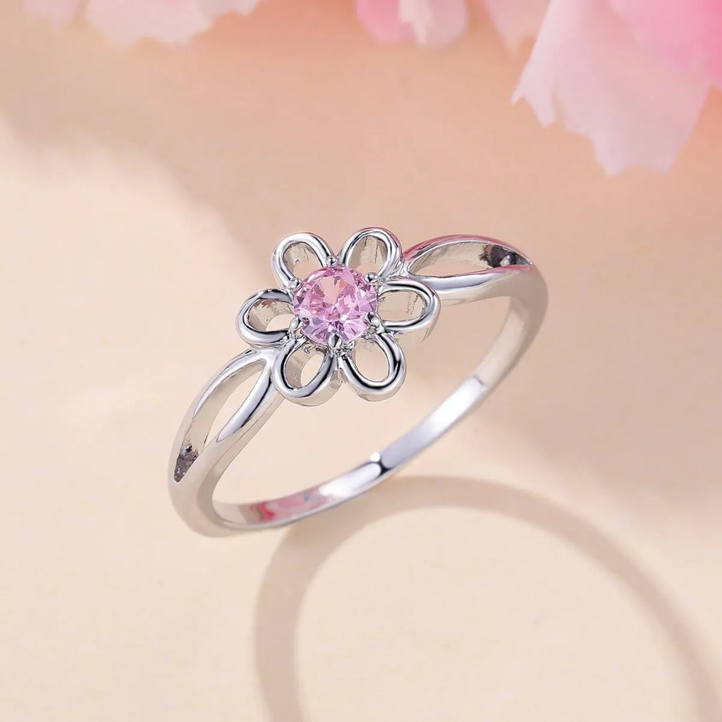 Women's hollowed flower fashion ring in copper with electroplated finish on a size chart.